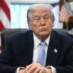 President Donald Trump signs an executive order in the Oval Office to reclassify marijuana as a less dangerous drug under federal law.