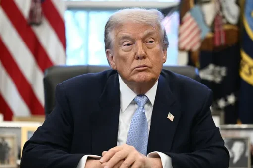 President Donald Trump signs an executive order in the Oval Office to reclassify marijuana as a less dangerous drug under federal law.